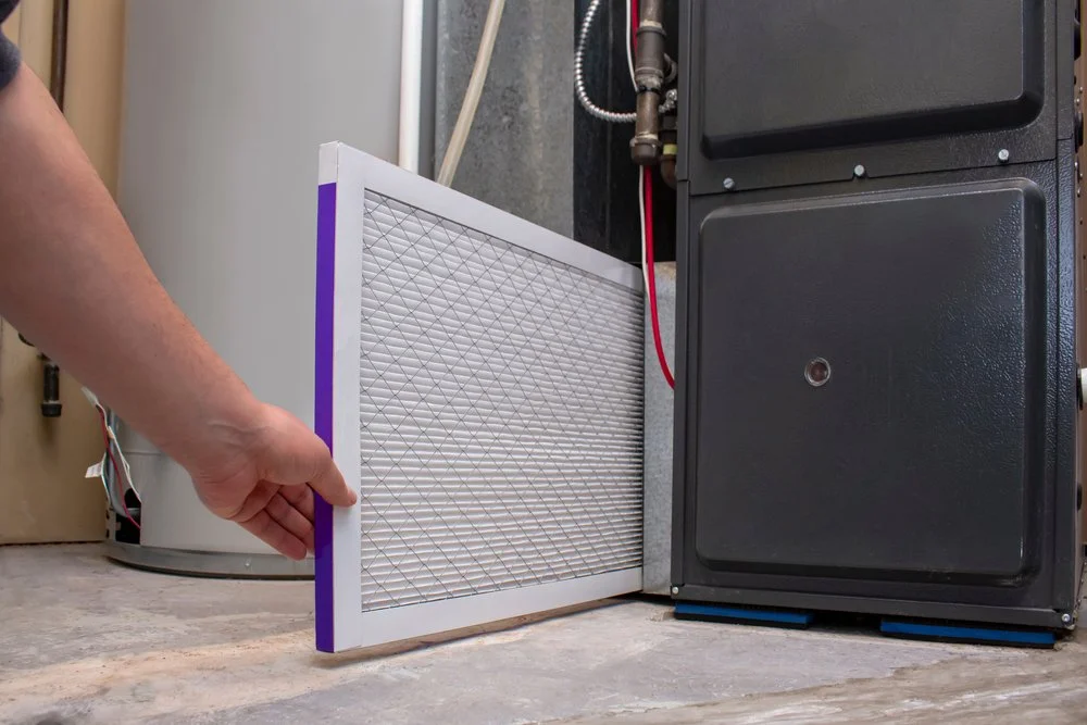 person-changing-clean-air-filter-on-furnace-cold-air-problem