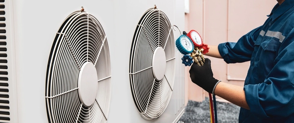 technician doing air conditioning maintenance
