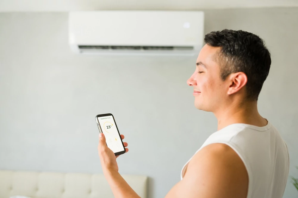 man looking at mini split unit
